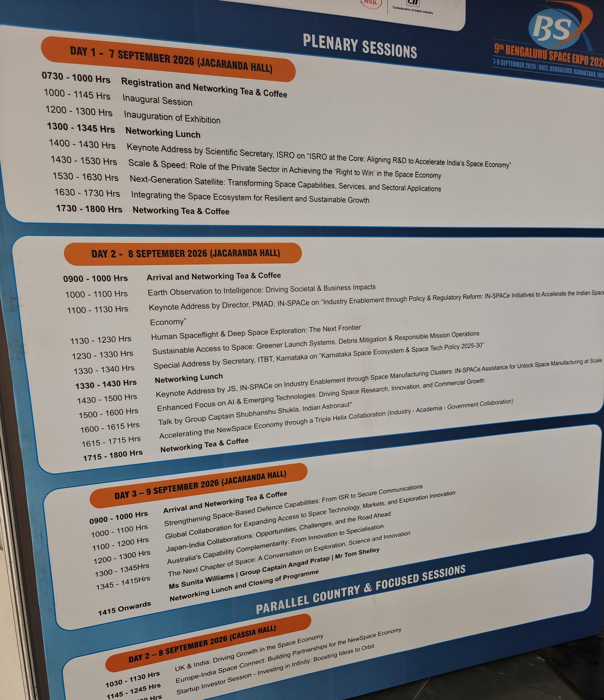 The printed programme board for Bengaluru Space Expo 2026 in Jacaranda Hall, listing the plenary sessions for 7, 8 and 9 September and the parallel country sessions in Cassia Hall.