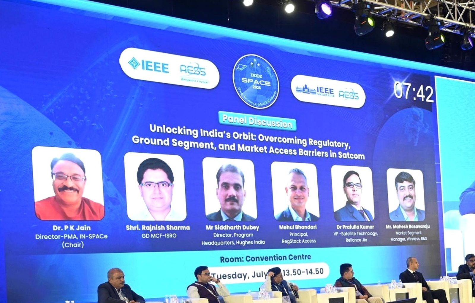 IEEE Space 2026 session board for the panel Unlocking India's Orbit, listing Dr P K Jain of IN-SPACe as chair with panelists from MCF-ISRO, Hughes India, RegStack Access, Reliance Jio and Rohde & Schwarz.